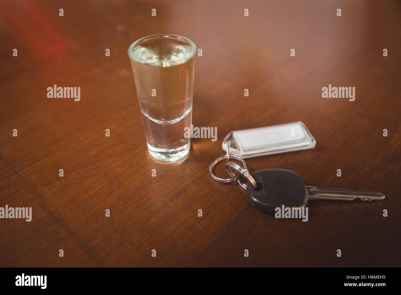 Glass of tequila shot with car key in bar counter Stock Photo Alamy