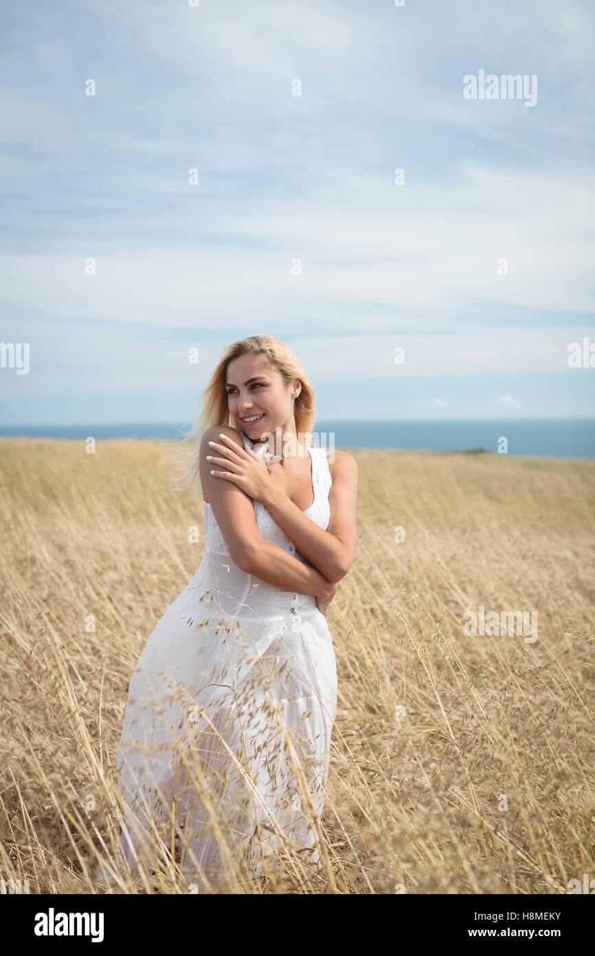 Blonde woman standing in field Stock Photo - Alamy