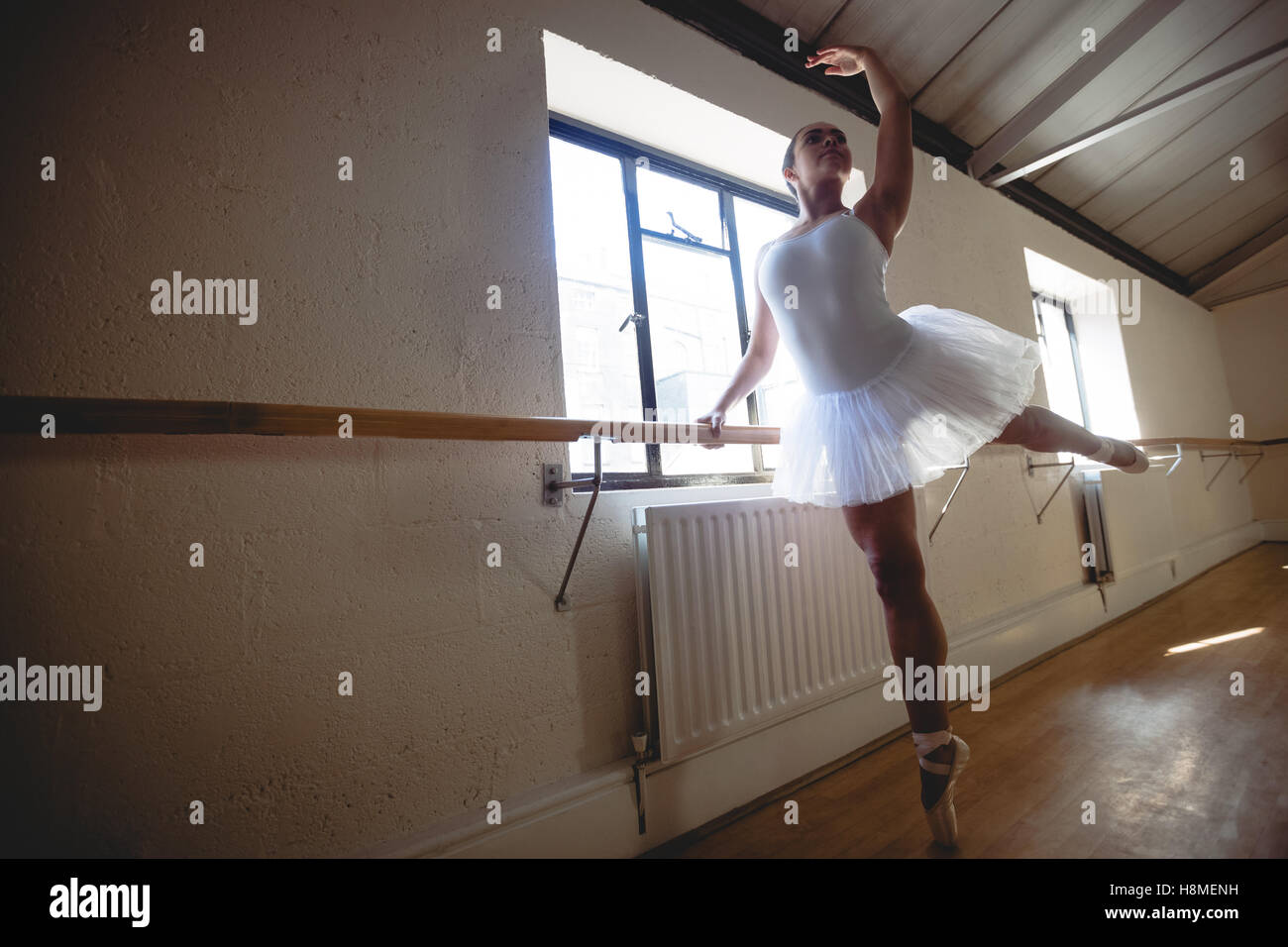 Ballerina practising ballet dance at barre Stock Photo