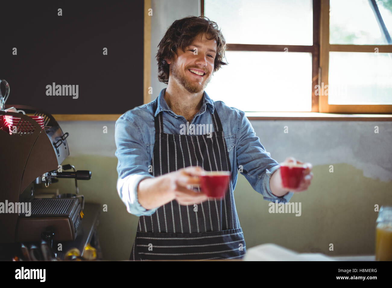 Waiter serving coffee at counter Stock Photo Alamy