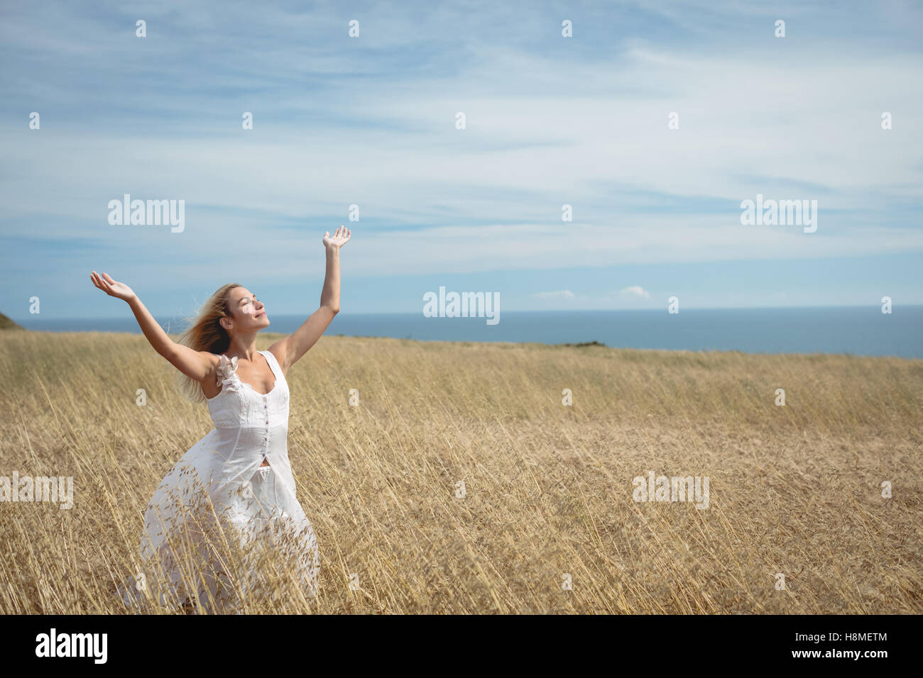 Woman standing raised arms hi-res stock photography and images - Alamy
