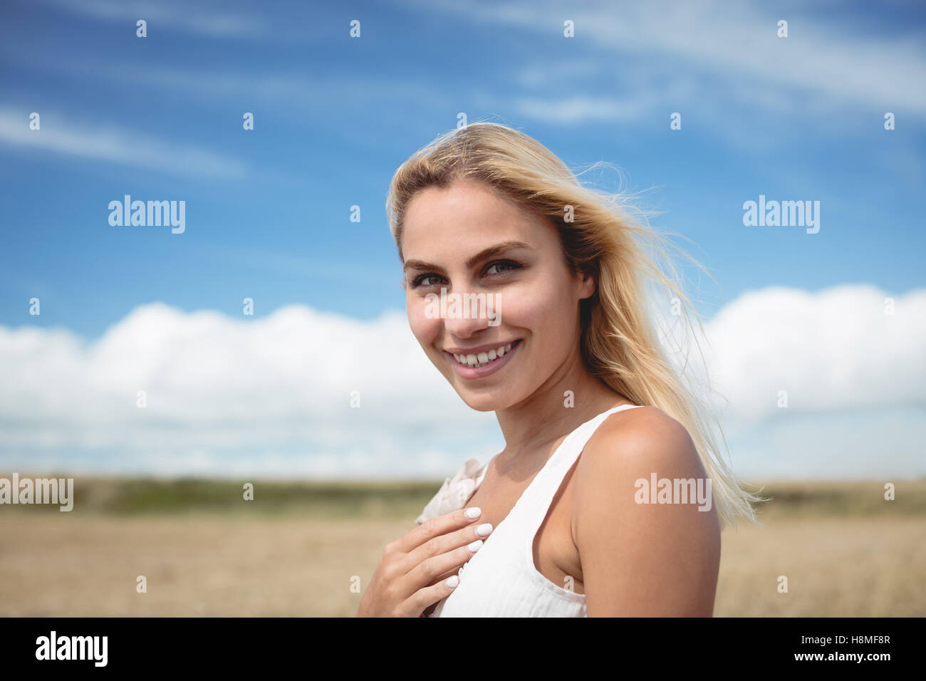 Portrait of carefree woman standing in field Stock Photo - Alamy
