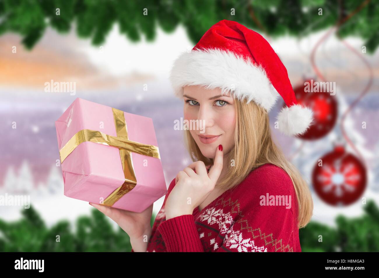 Beautiful woman in santa hat holding a gift box Stock Photo - Alamy