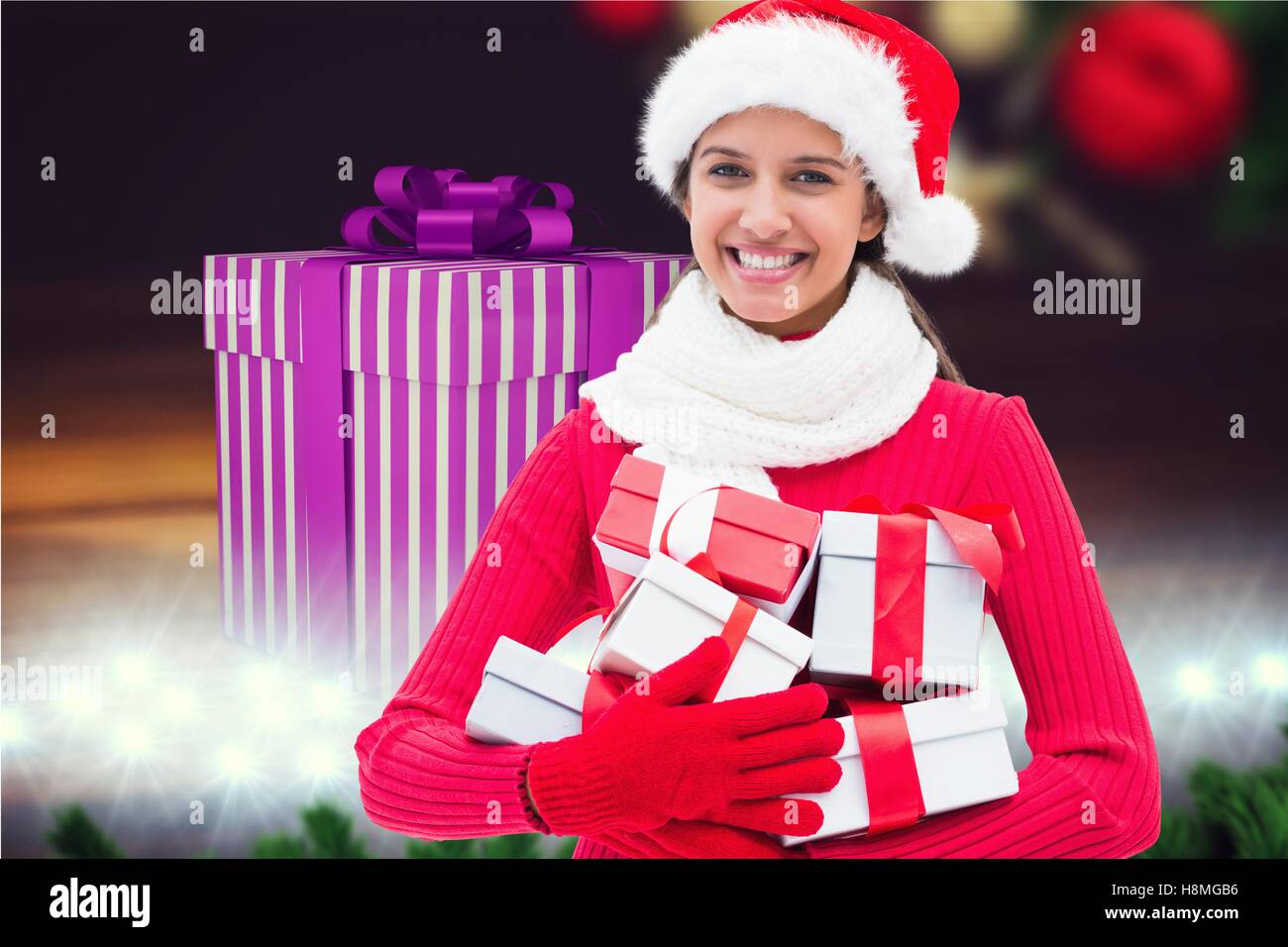 Beautiful woman in santa costume holding stack of gift boxes Stock ...