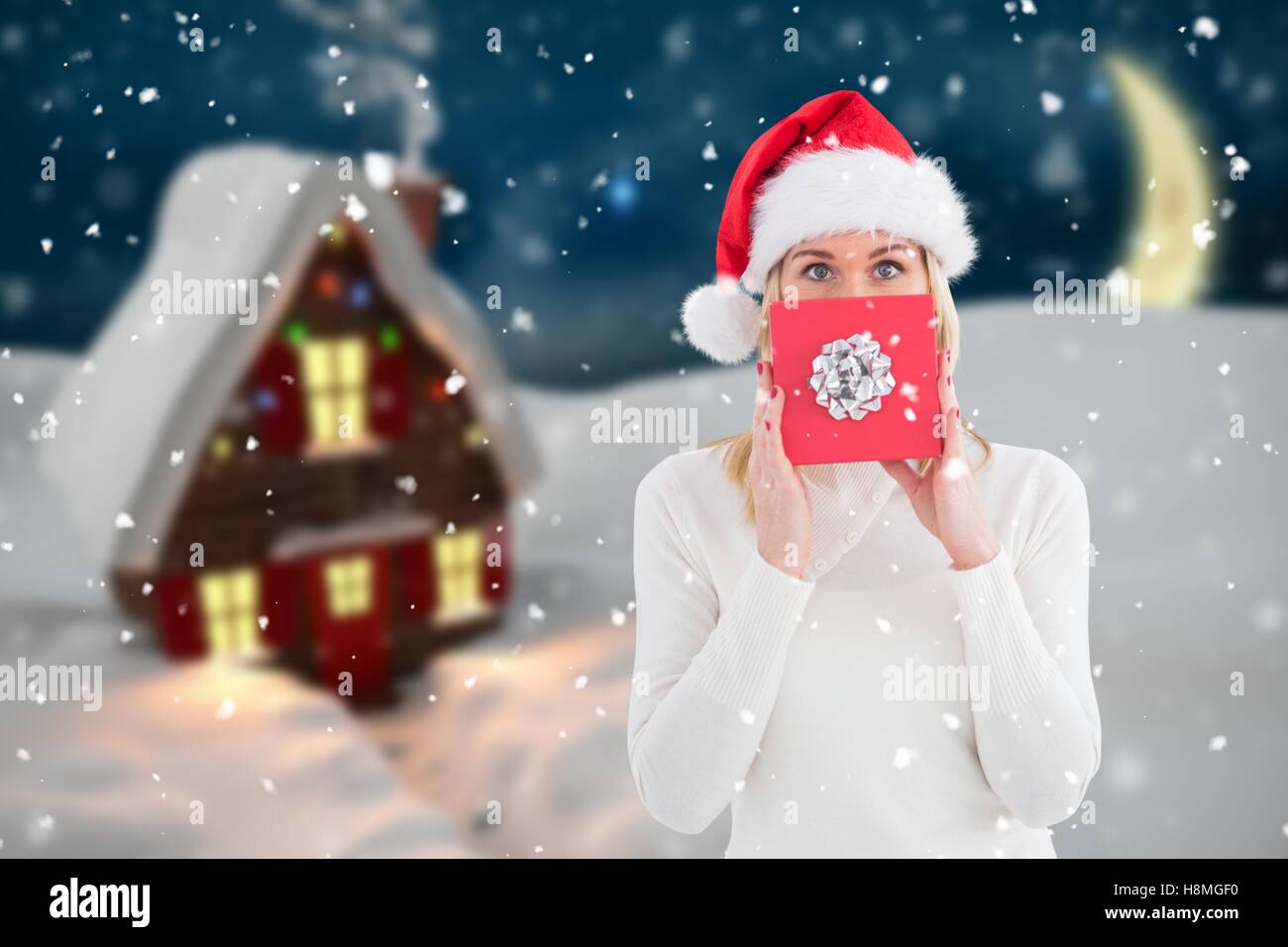 Beautiful woman in santa hat holding a gift box Stock Photo