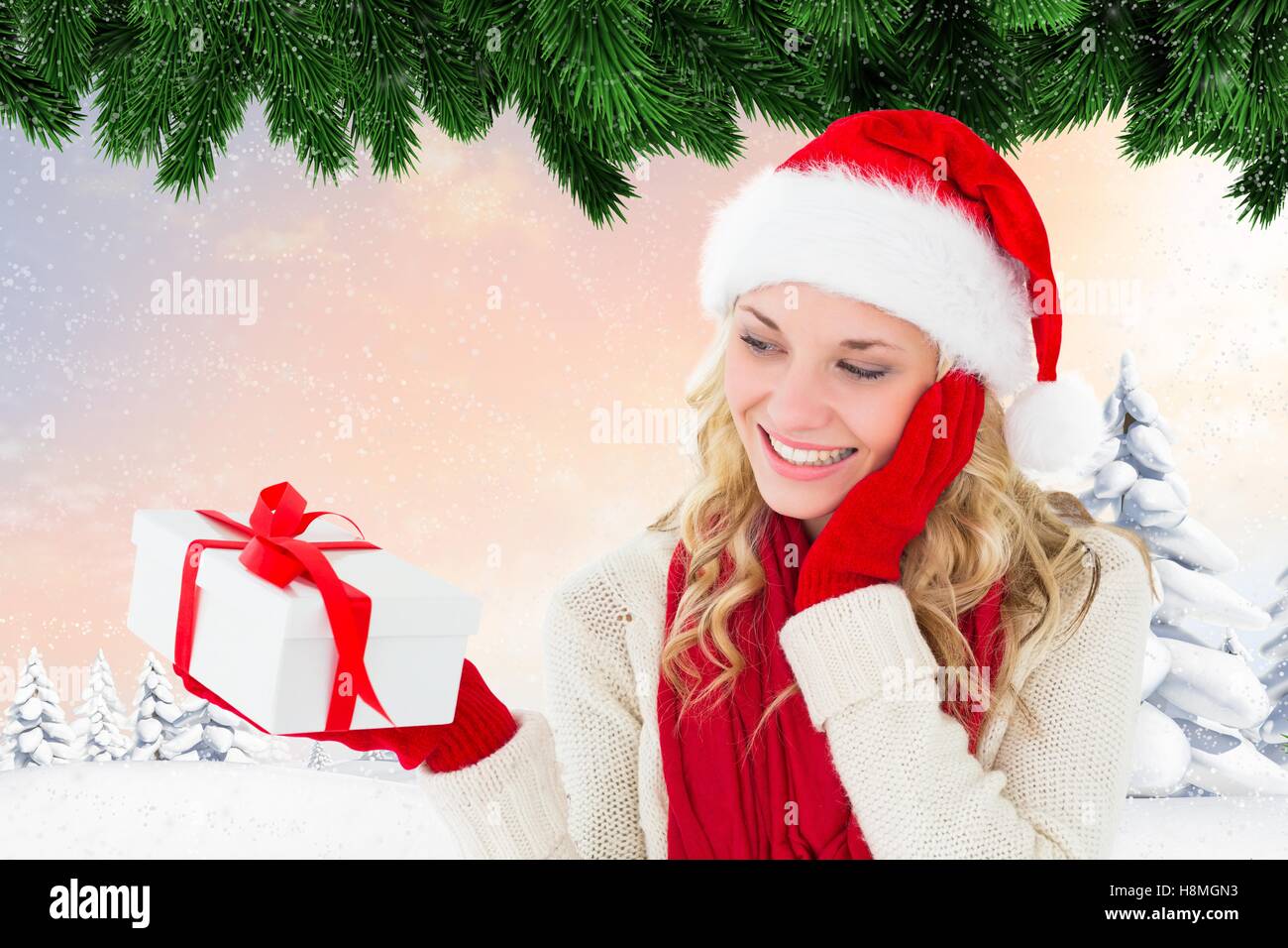 Beautiful woman in santa hat holding a gift box Stock Photo - Alamy