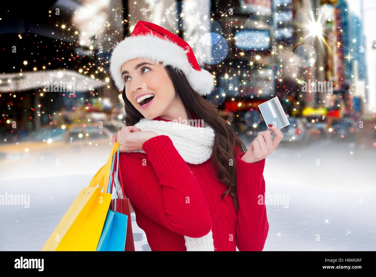 Cheerful woman in santa costume holding shopping bag and credit card Stock Photo