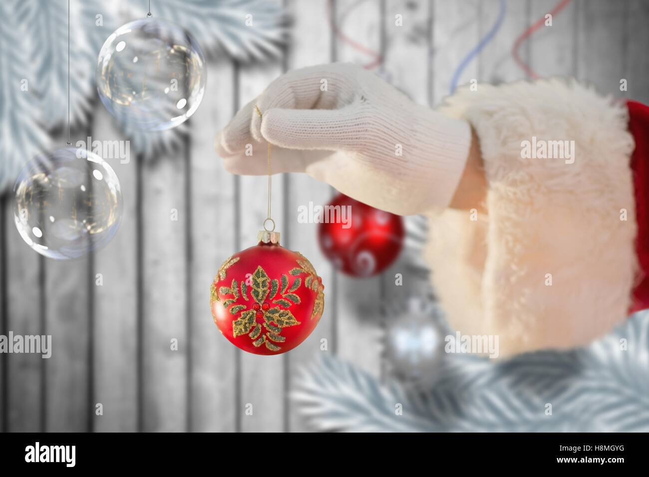 Santa claus holding a christmas bauble Stock Photo