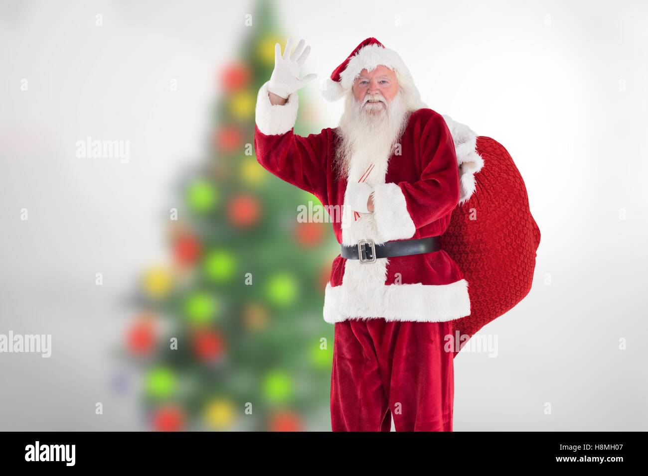 Santa claus waving his hand during christmas time Stock Photo