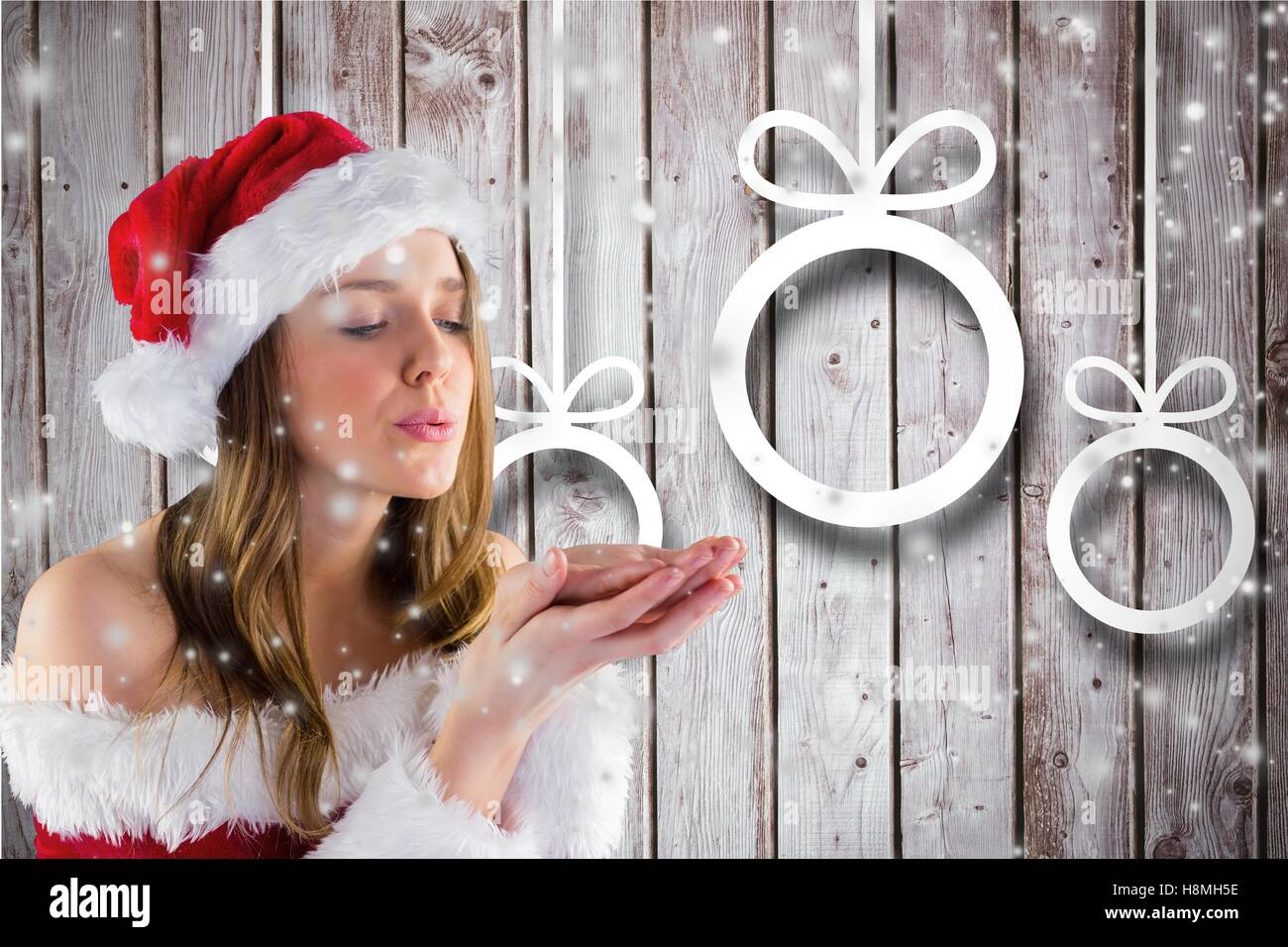 Woman in santa costume blowing snowflakes Stock Photo