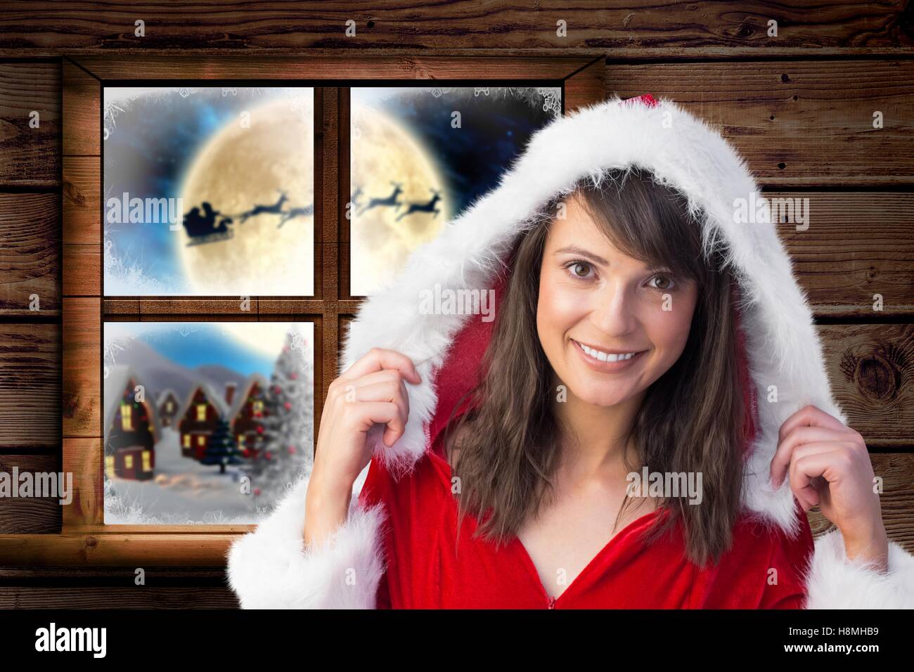 Woman in santa costume smiling at camera Stock Photo