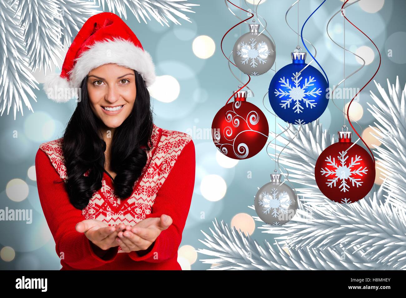 Happy woman with hands cupped standing against digitally generated christmas background Stock Photo