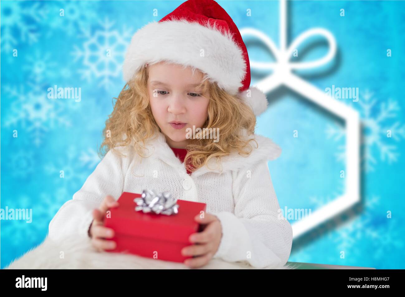 Girl in santa hat holding a gift box Stock Photo - Alamy