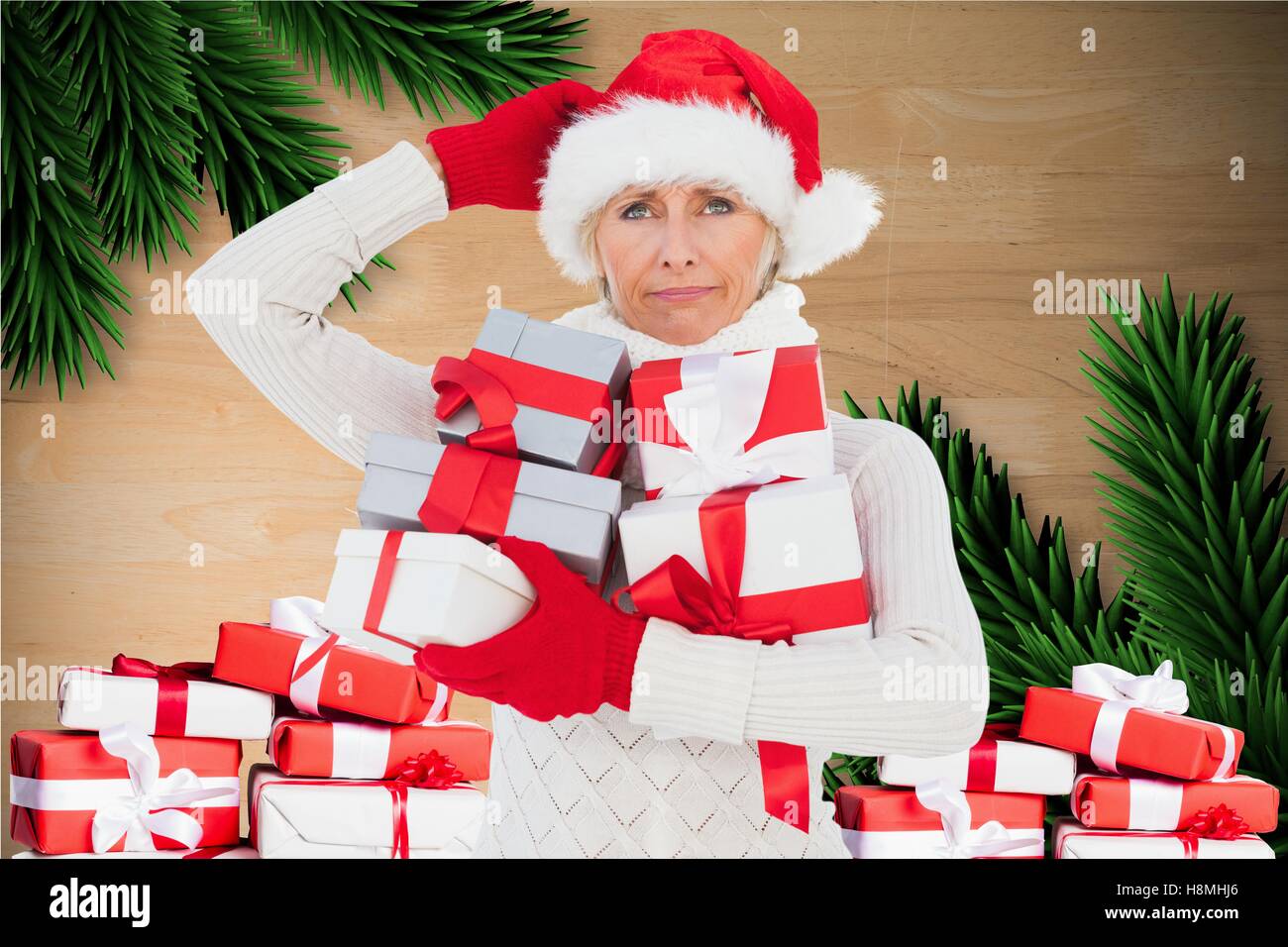 Confused woman in santa hat holding christmas gift Stock Photo