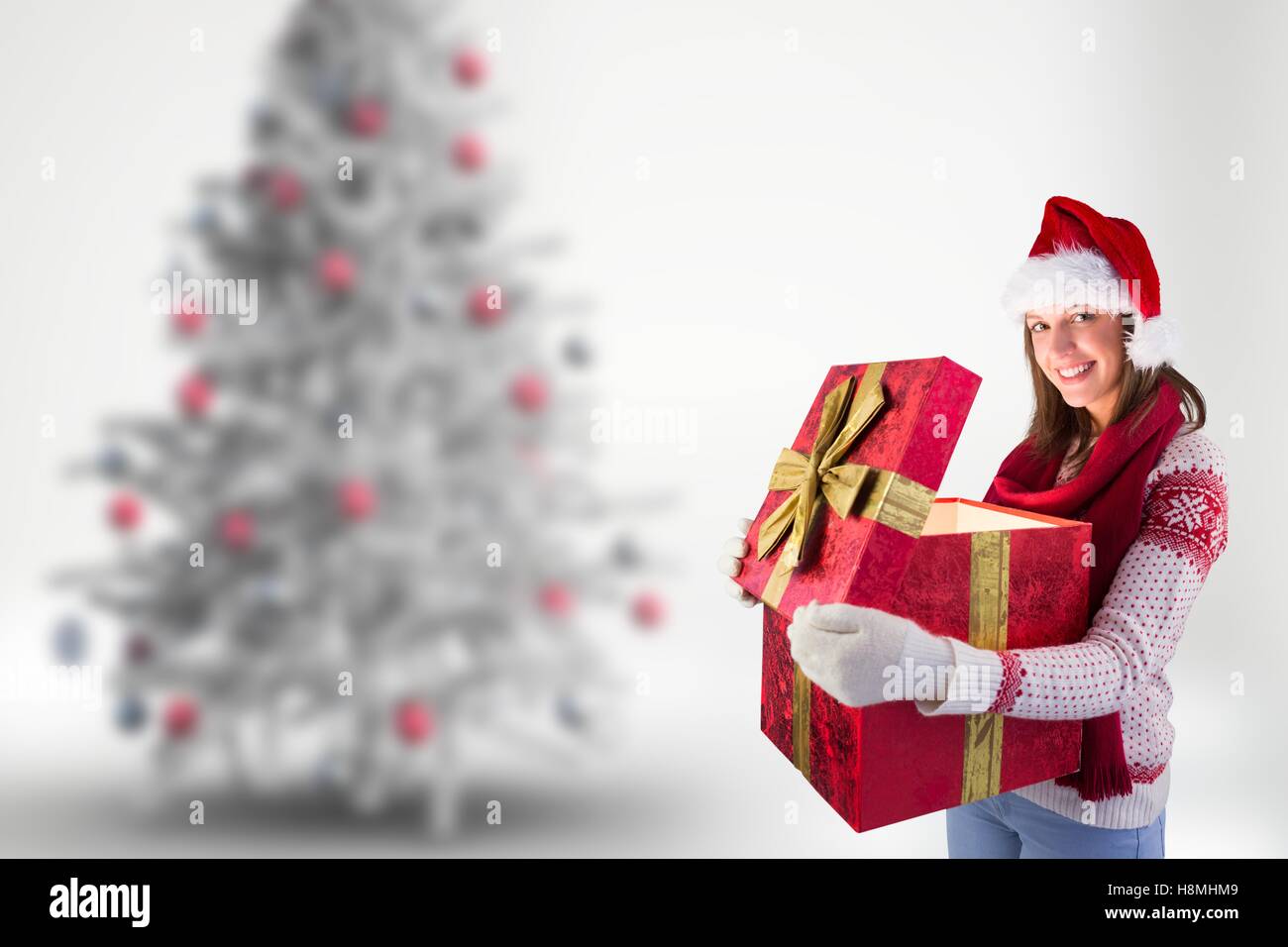 Woman in santa hat holding her big christmas gift box Stock Photo - Alamy