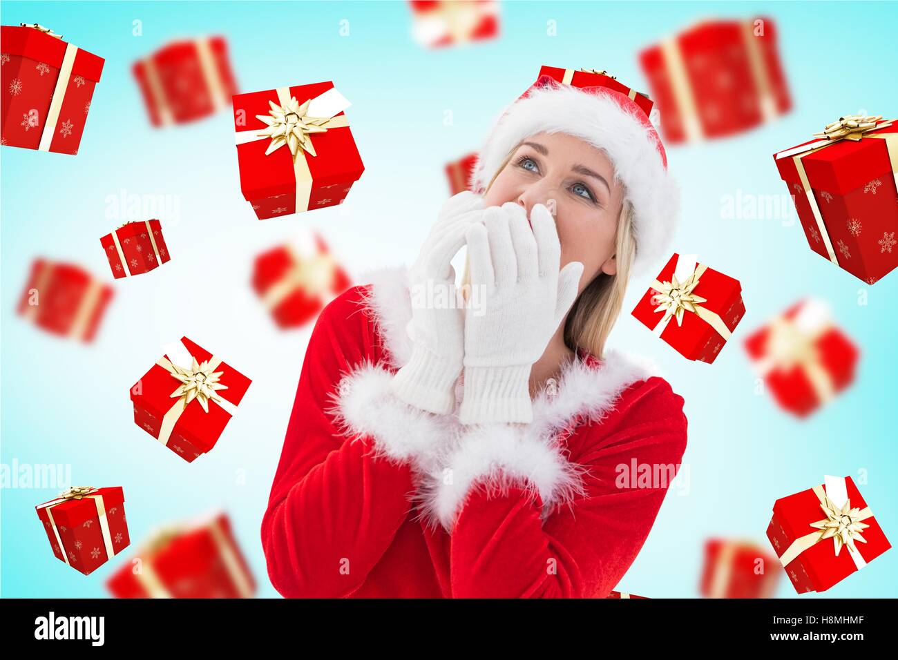 Surprised woman in santa costume against digitally generated background Stock Photo