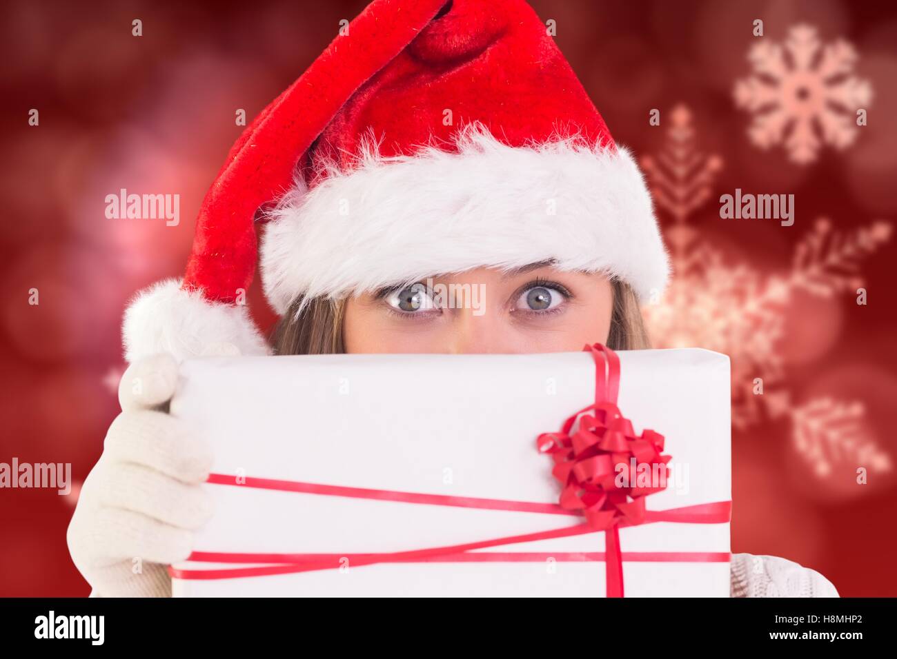 Woman in santa hat holding gift box Stock Photo