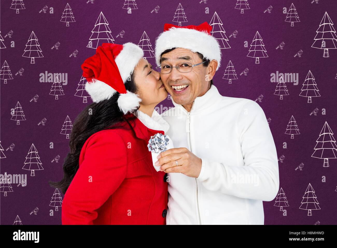 Woman kissing man on cheeks against digitally generated background Stock Photo