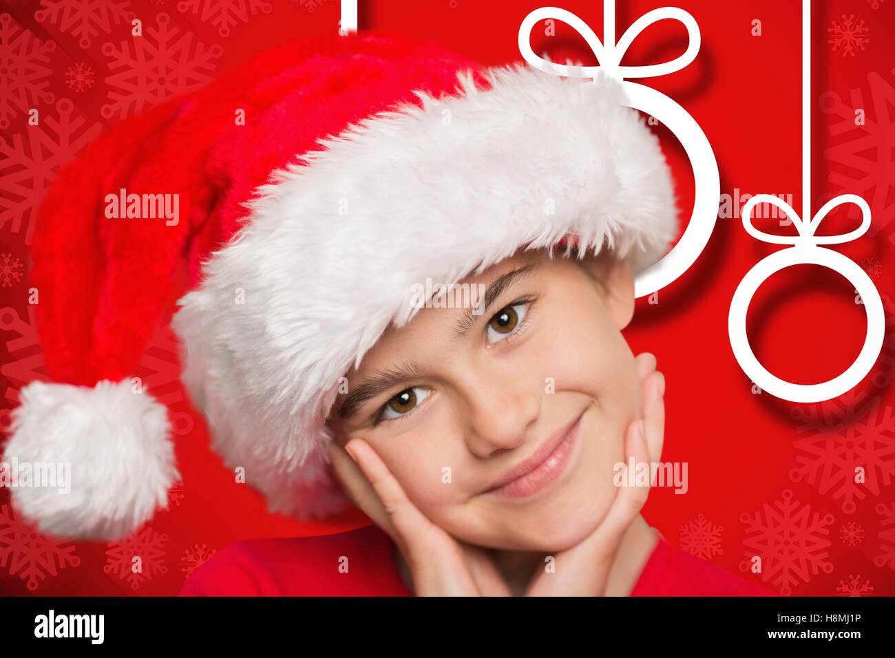 Portrait of happy boy wearing santa hat Stock Photo
