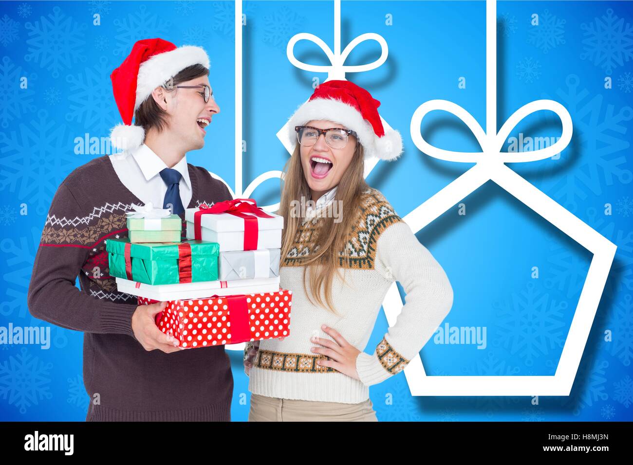 Happy couple in santa hat holding christmas gifts Stock Photo