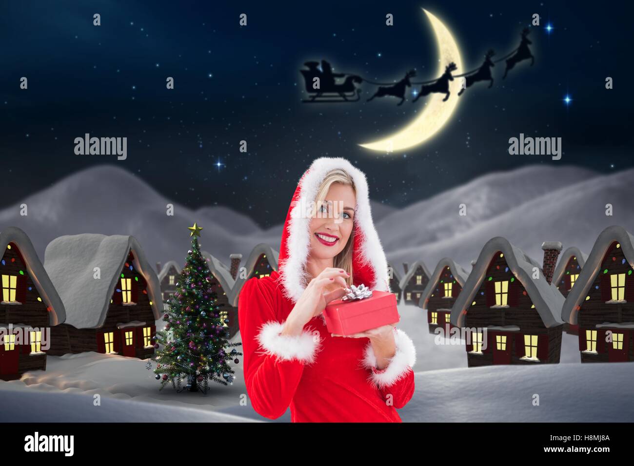Beautiful woman in santa costume holding a gift box Stock Photo - Alamy
