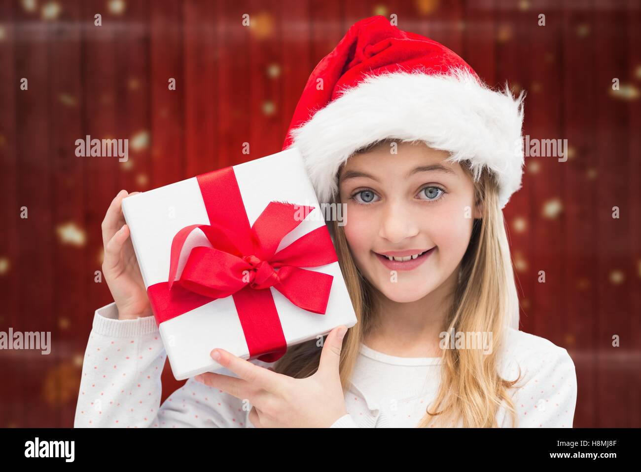 Girl in santa hat holding christmas gifts Stock Photo