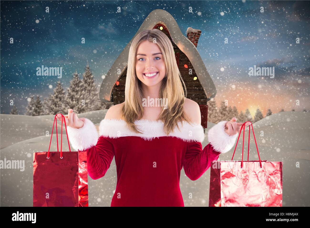 Beautiful woman in santa hat holding shopping bags Stock Photo