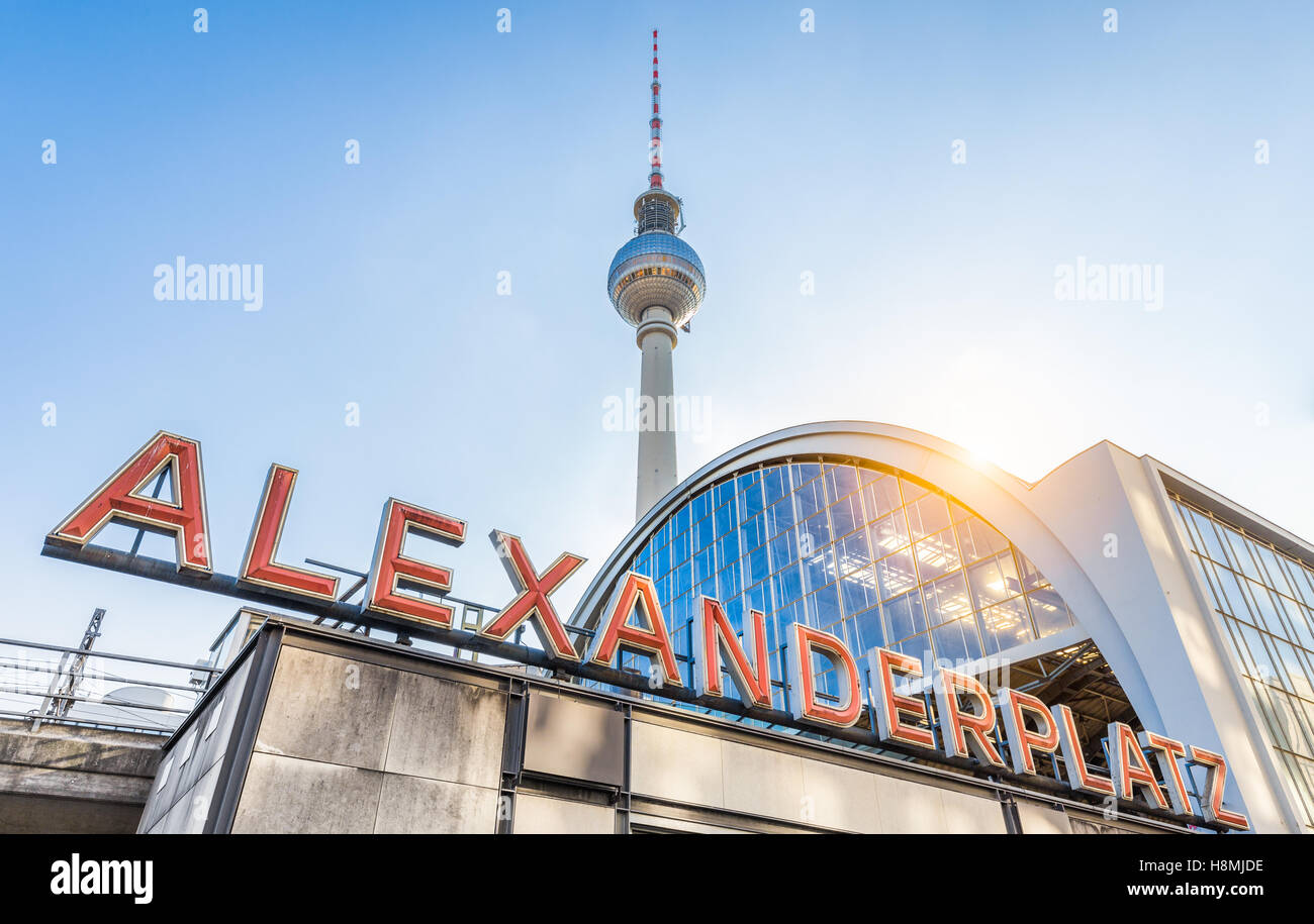 Classic wide-angle view of Alexanderplatz neon sign with famous TV tower and train station at sunset, Berlin, Germany Stock Photo