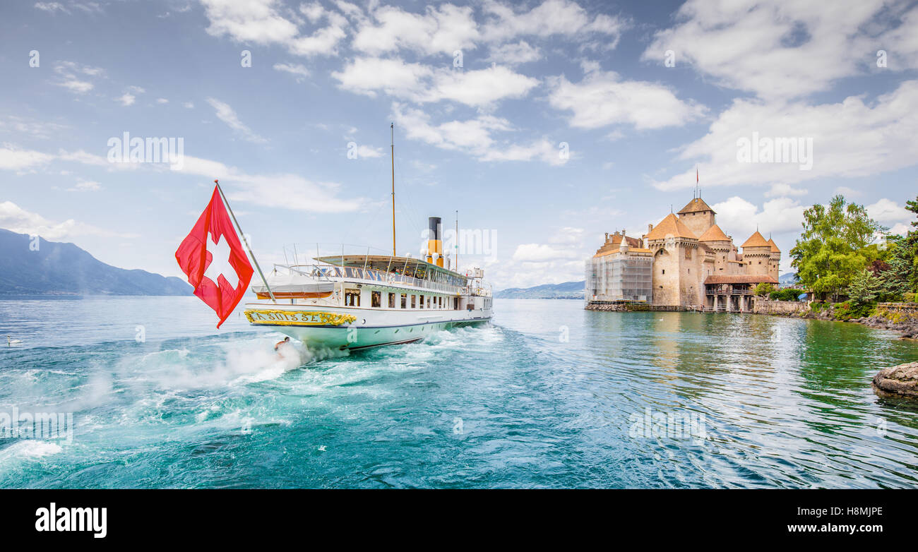 Traditional paddle steamer excursion ship with famous Chateau de Chillon at Lake Geneva in summer, Canton of Vaud, Switzerland Stock Photo