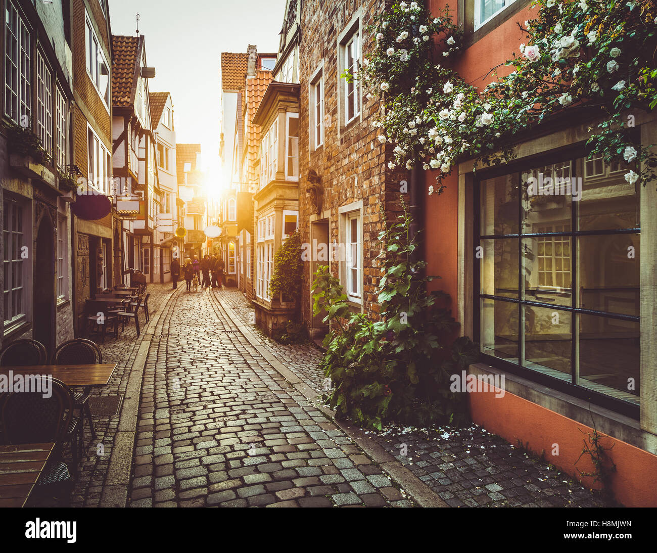 Enchanting street scene in an old town in Europe at sunset with pastel ...
