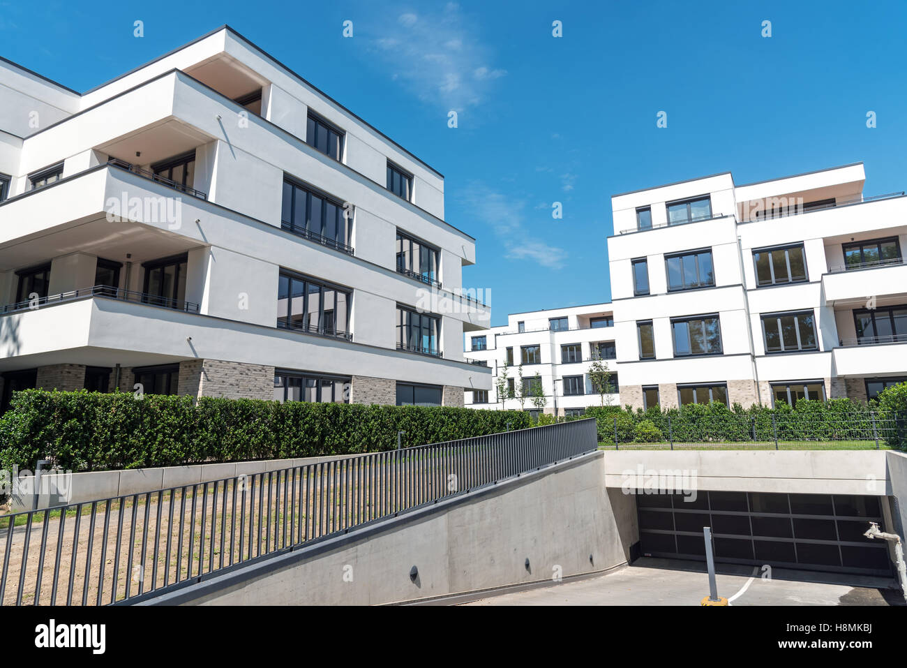 Modern white apartment houses with an underground parking seen in