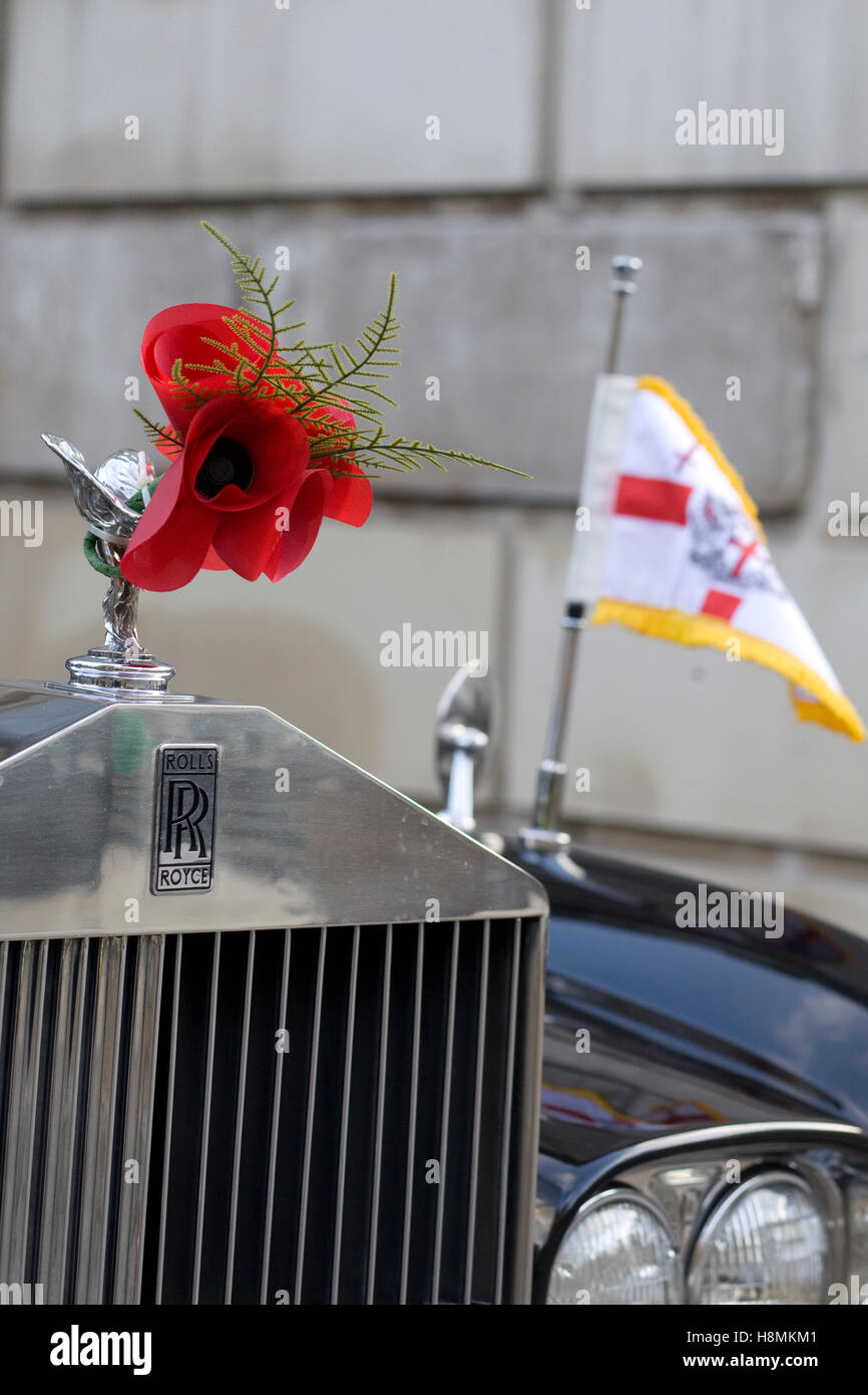 Poppies attached to the hood ornament on a Rolls Royce Stock Photo