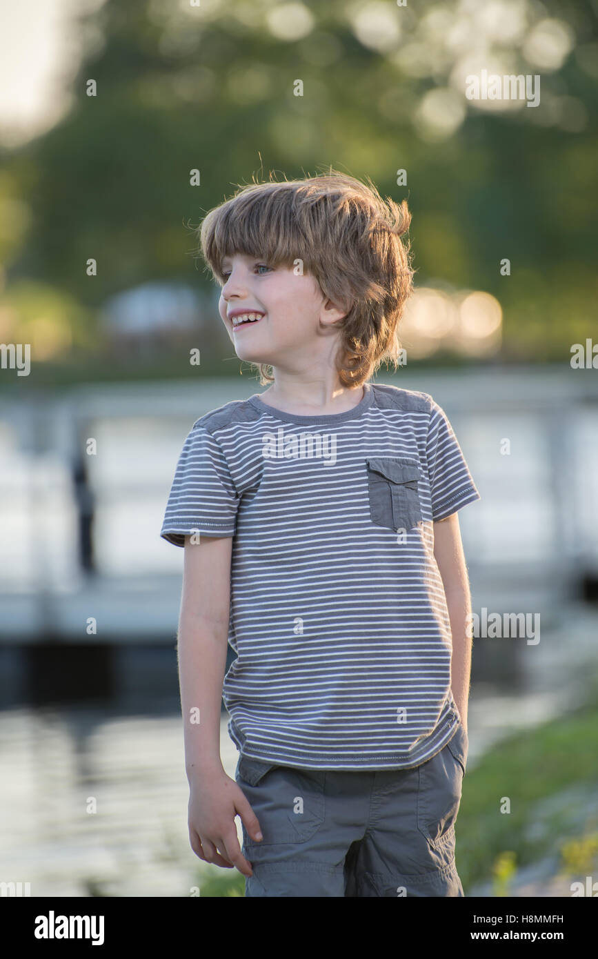 Portrait of a young boy in a park with blurred background Stock Photo