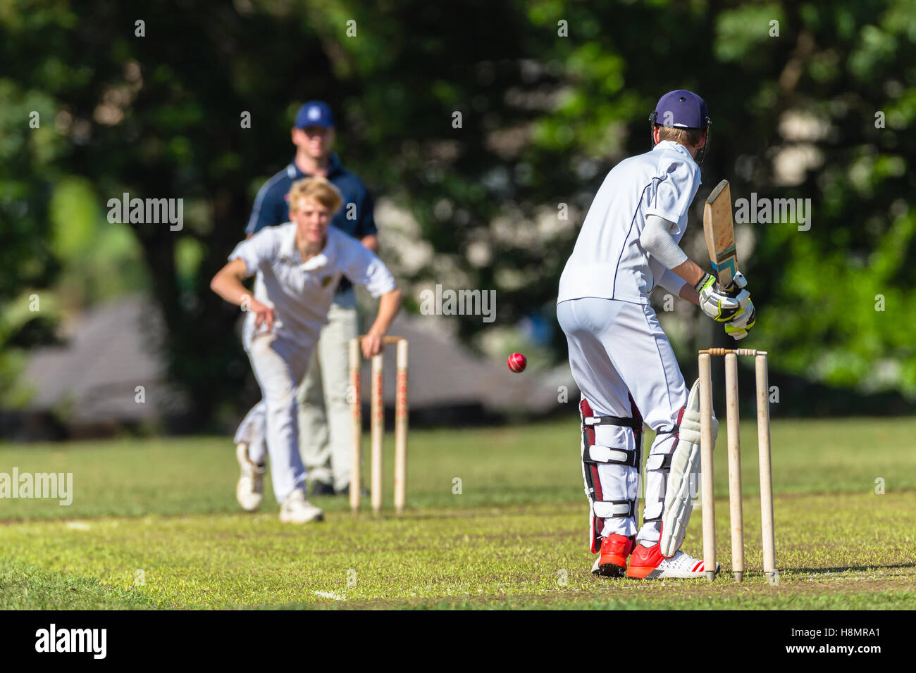 Cricket game teenagers high schools batsman bowler ball striking action