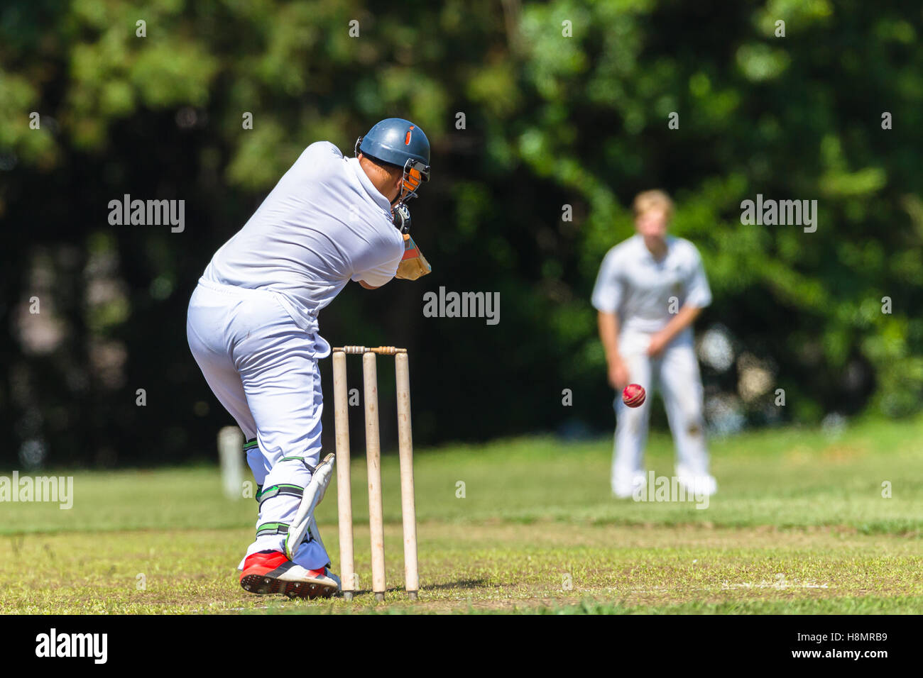 Cricket game teenagers high schools batsman bowler ball striking action
