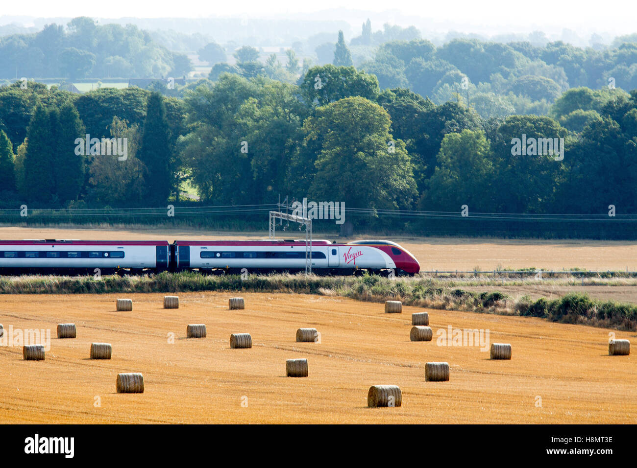 A Virgin train traveling between Atherstone to Polesworth on Trent Valley line. Stock Photo