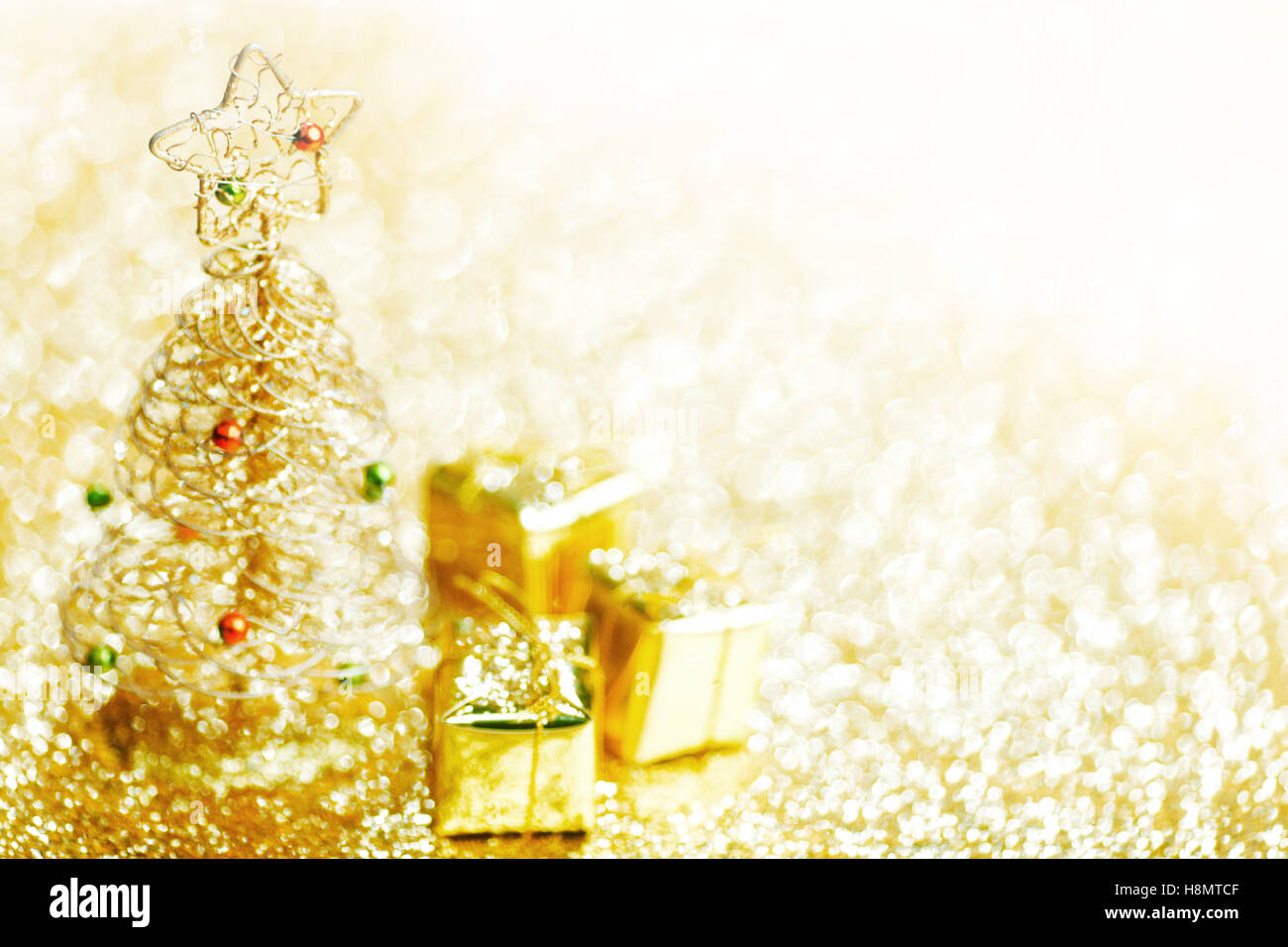 Toy golden decorative Christmas tree on glitter background Stock Photo ...