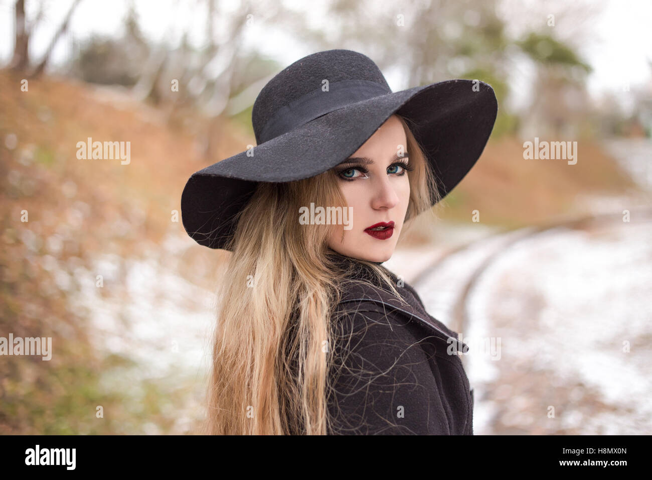 Portrait of a young beautiful woman in black hat retro style Stock ...
