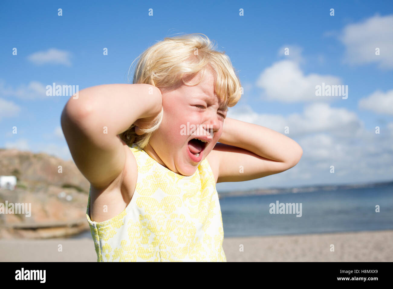 Girl (4-5) screaming on beach Stock Photo