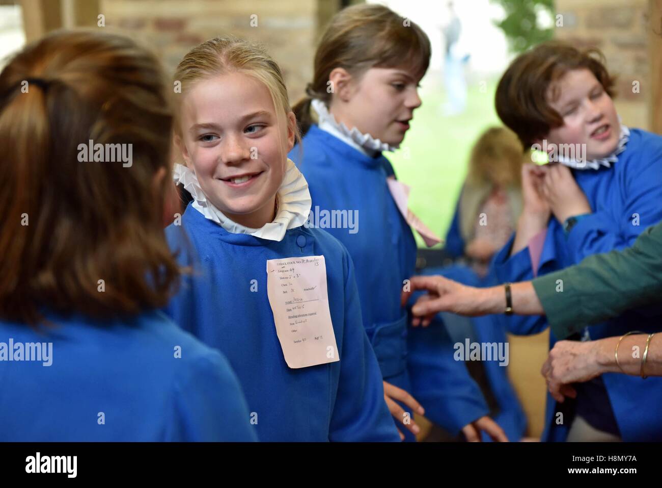 Girl choristers at cassock fitting and rehearsing for evensong. Stock Photo