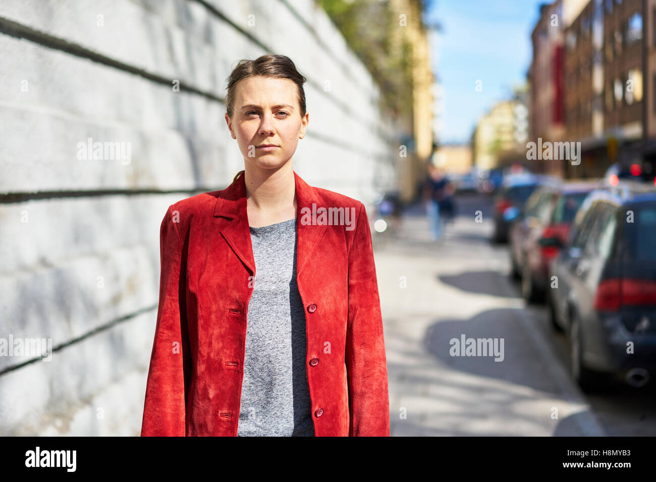 Woman in red jacket looking at camera Stock Photo