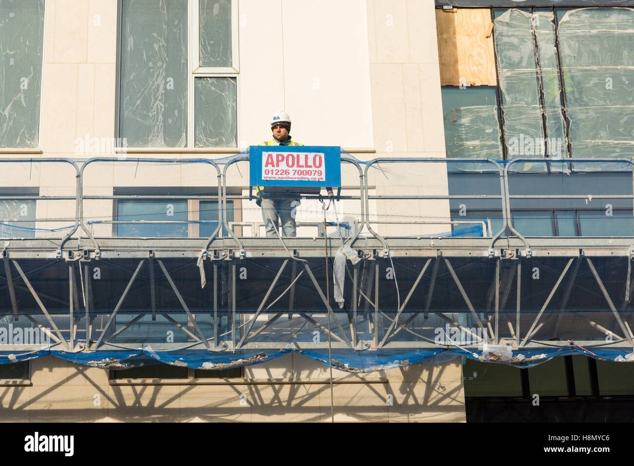 A construction worker on scaffolding on a building site in Cambridge UK Stock Photo