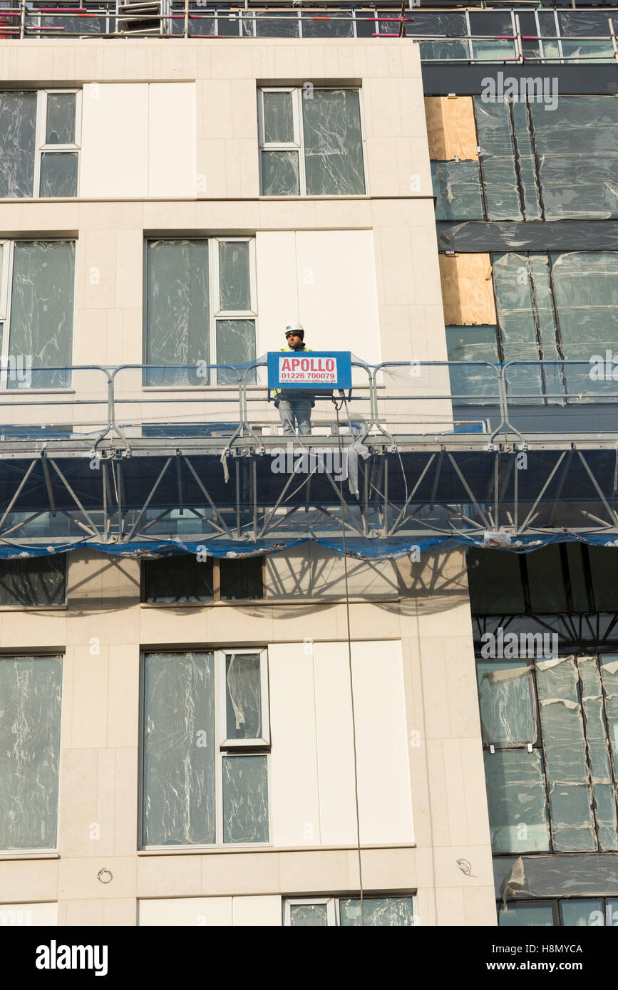 A construction worker on scaffolding on a building site in Cambridge UK Stock Photo