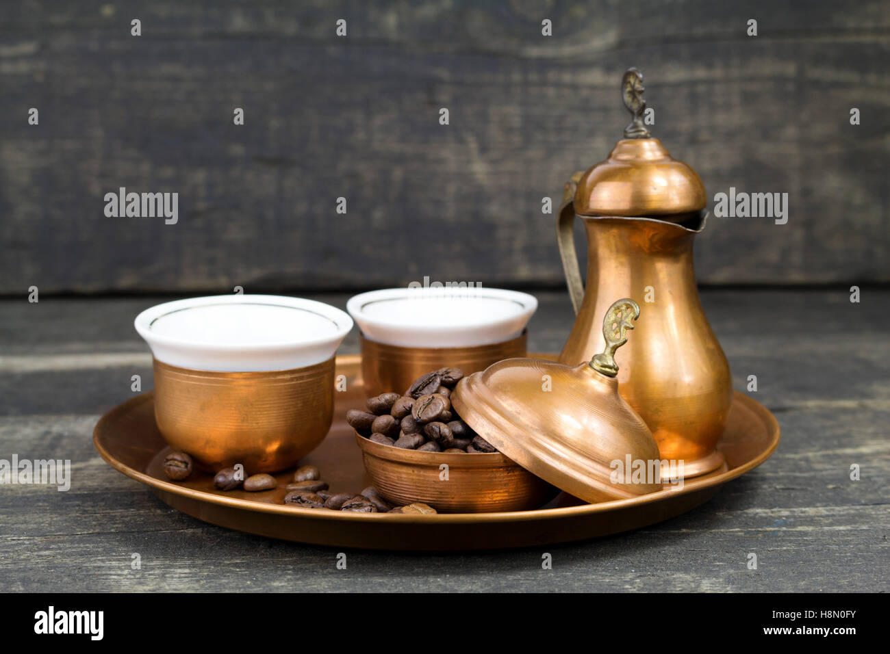 Turkish coffee with traditional copper serving set and coffee beans