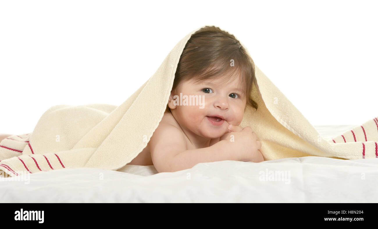 Baby girl lying under blanket Stock Photo Alamy