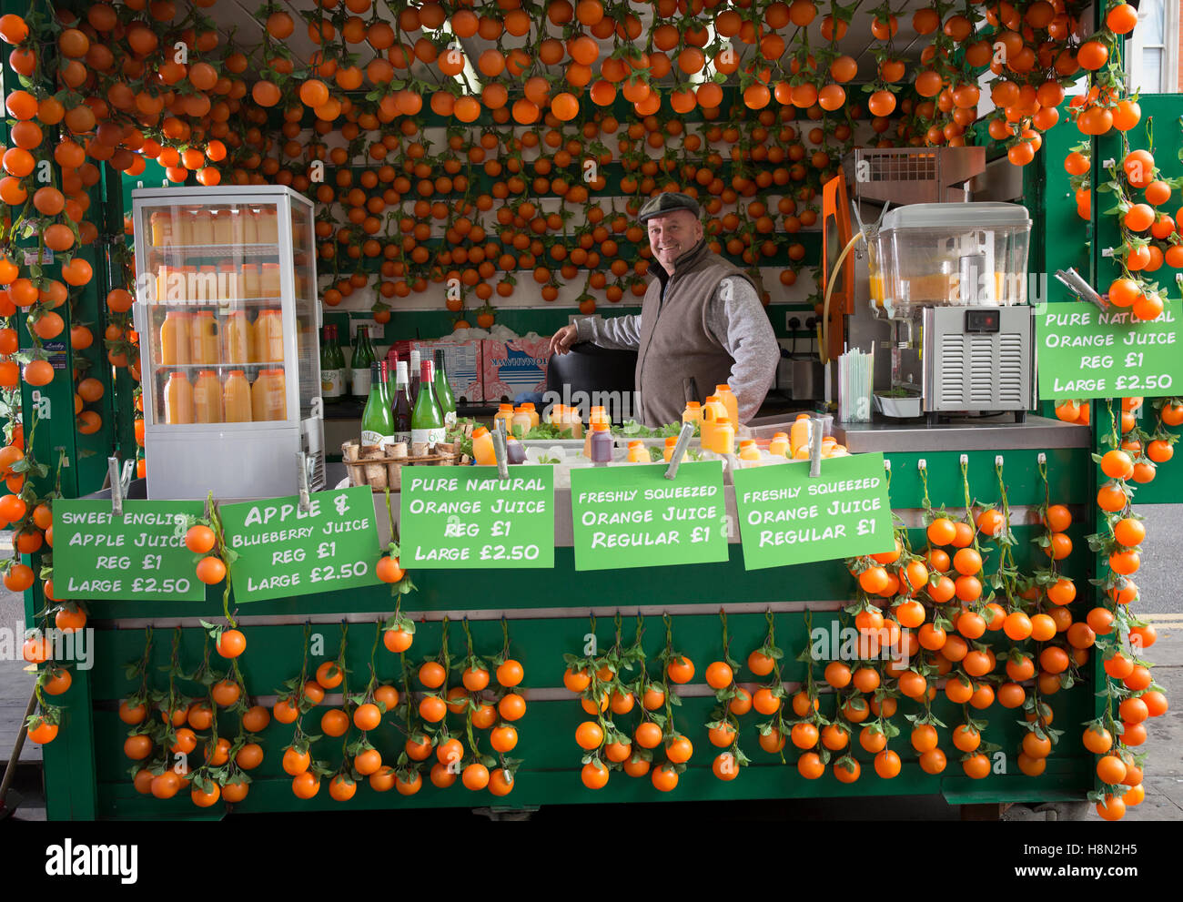 Gerry O'Brien works in his orange juice stand on Kilburn High Road in northwest London Stock