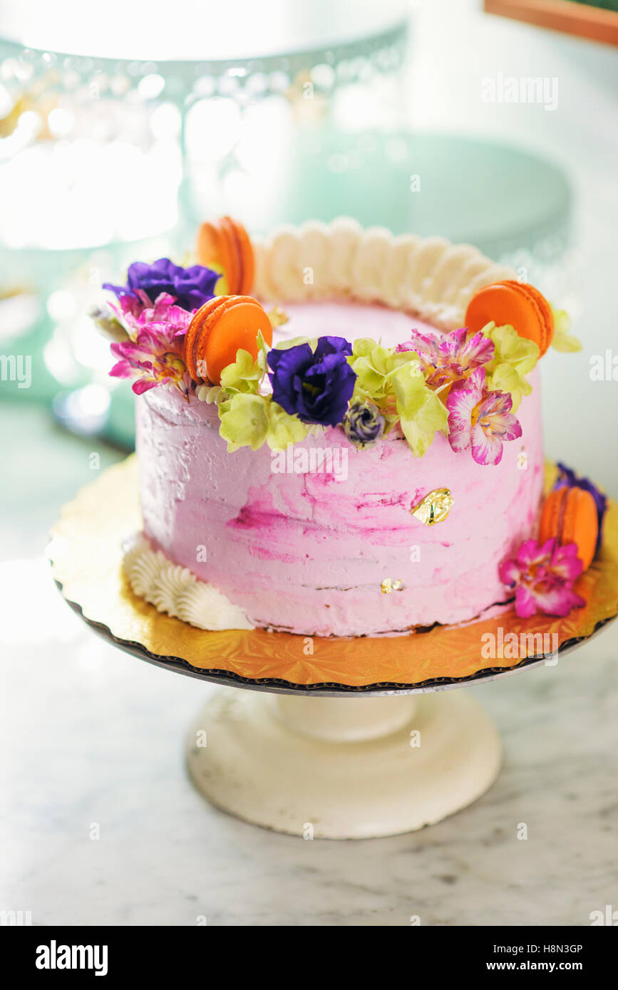 Pink cake on cake stand Stock Photo
