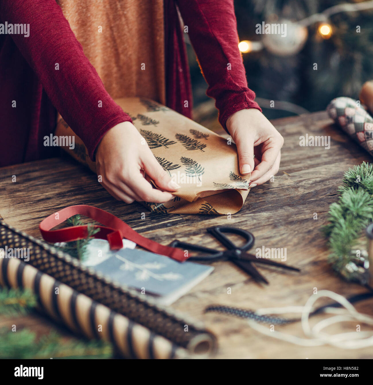 Woman Wrapping and Decorating Christmas Present Stock Photo Alamy