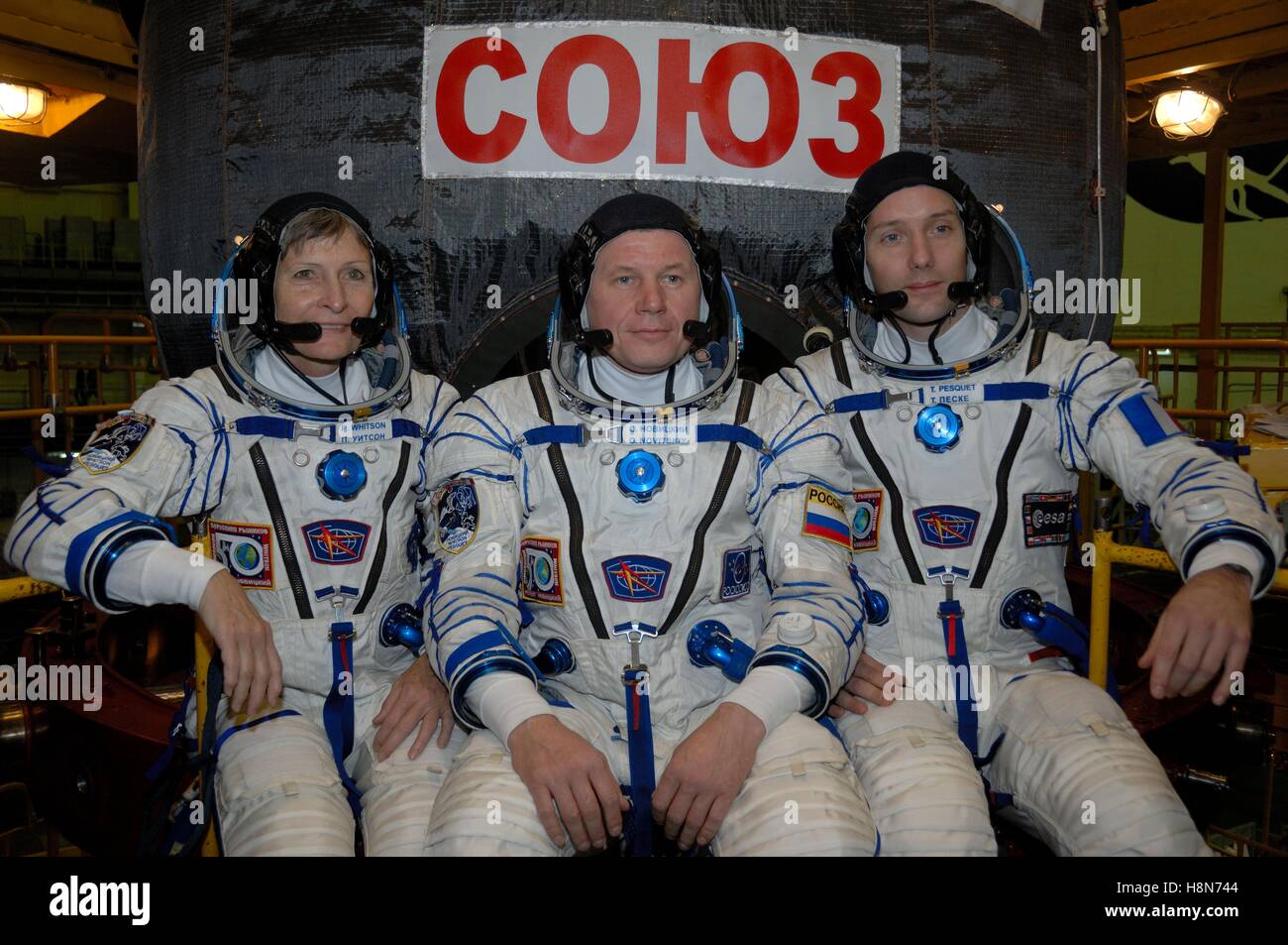NASA International Space Station Expedition 50-51 prime crew members (left to right) astronaut Peggy Whitson, Russian cosmonaut Oleg Novitskiy of Roscosmos, and astronaut Thomas Pesquet of the European Space Agency pose in front of the Soyuz MS-03 spacecraft during a fit check dress rehearsal at the Baikonur Cosmodrome Integration Facility November 2, 2016 in Baikonur, Kazakhstan. Stock Photo