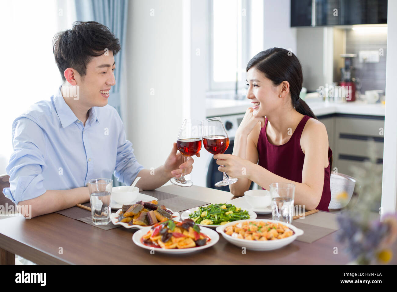 Romantic young Chinese couple dining at home Stock Photo